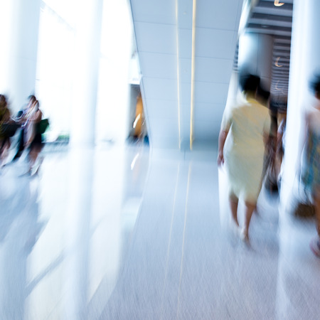 Business people rushing in the lobby. motion blurの写真素材