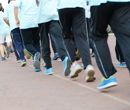 Group of students running on a racing track.の写真素材