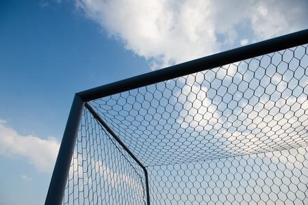 soccer goal against cloudy sky background.の写真素材