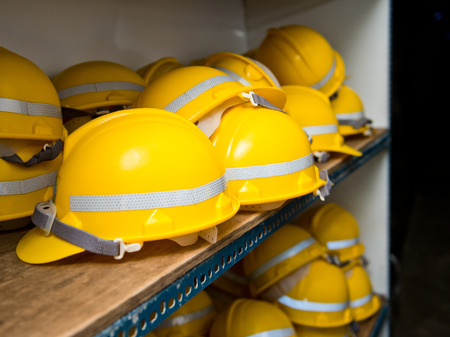Some yellow construction helmets on work place.の写真素材