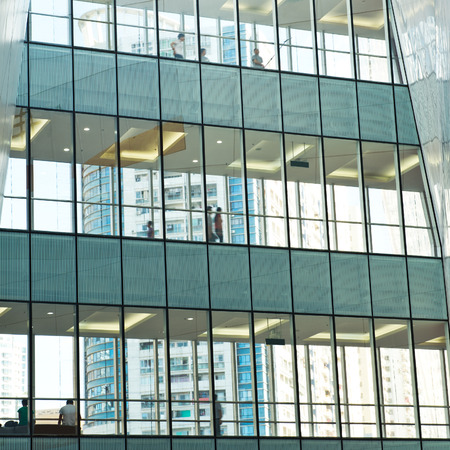 silhouettes of business people rushing at morden office building.のeditorial素材
