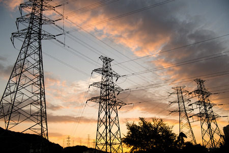 high voltage post at sunset.の写真素材