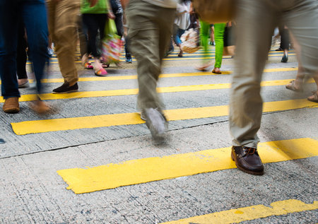 Busy city people on zebra crossing street in Hong Kong, China.