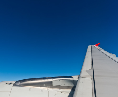Airplane at fly on the sky, view through aircraft window.の写真素材