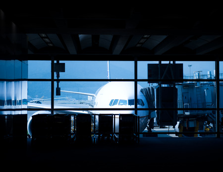 Parked aircraft on hong kong airport through the gate window.の写真素材
