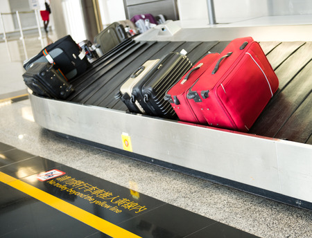 suitcases on conveyor belt of airport.の写真素材