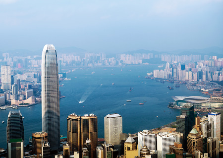 Hong Kong cityscape with victoria harbour and large group of tall buildings.の写真素材