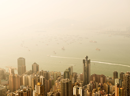 Hong Kong cityscape with victoria harbour and large group of tall buildings.の写真素材