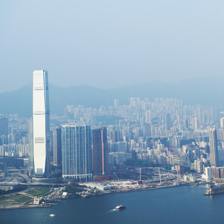 Hong Kong cityscape with victoria harbour and large group of tall buildings.の写真素材