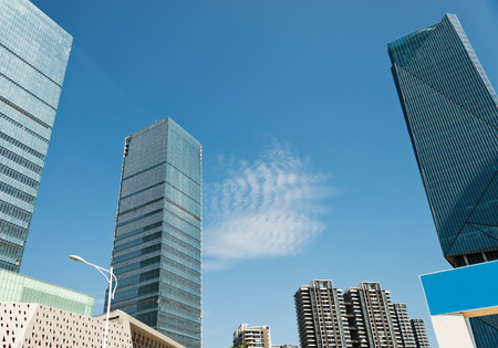 Modern glass building skyscrapers over blue sky.の写真素材