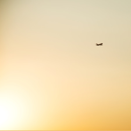Airplane is flying in the sky among clouds.の写真素材