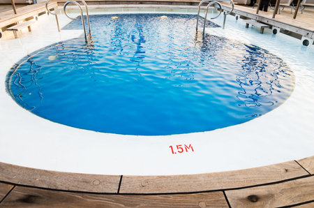 Background of rippled pattern of clean water in a blue swimming pool