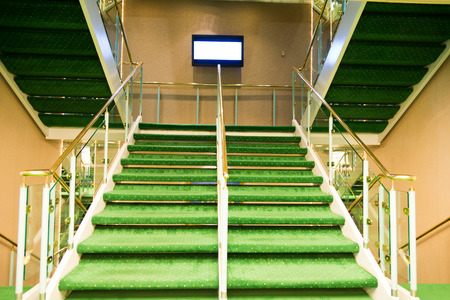 Green carpet on a stairway in a luxury cruise.のeditorial素材