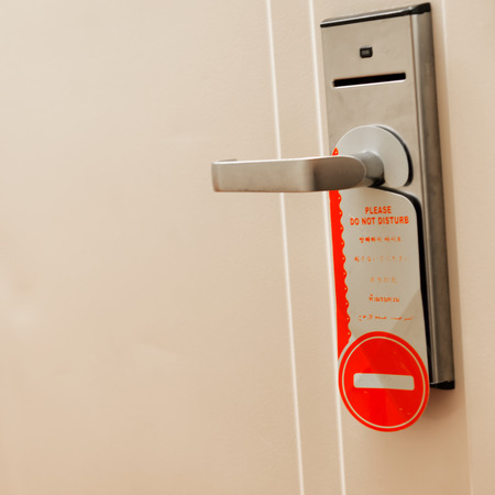 Do not disturb sign hang on hotel door knob.の写真素材