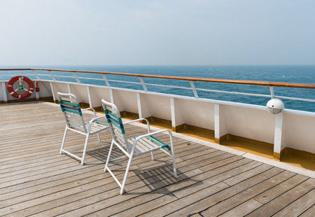 row of sun chairs  on the ship deckの写真素材