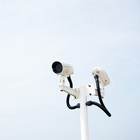 CCTV security camera isolated on sky background.の写真素材