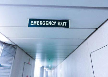 exit sign suspended from the ceiling of cruise ship corridor.の写真素材