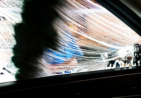 Car wash with flowing water and foam.の写真素材