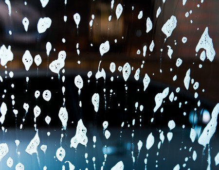 Car wash with flowing water and foam.の写真素材