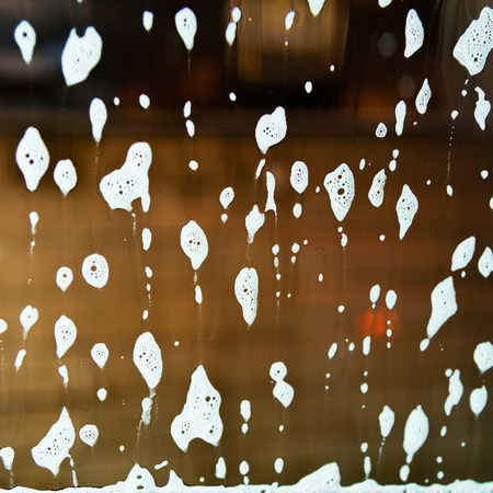 Car wash with flowing water and foam.の写真素材
