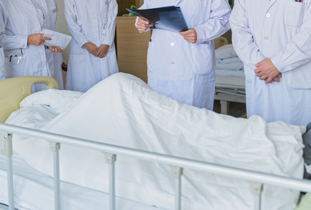 Medical team examining patient in hospital. の写真素材