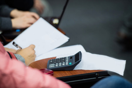 Closeup of human hand writing at a conference.の写真素材