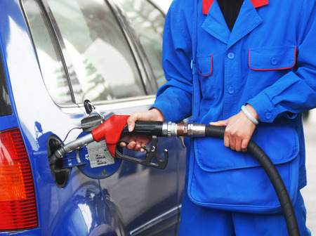 Hand refilling the car with fuel.の写真素材