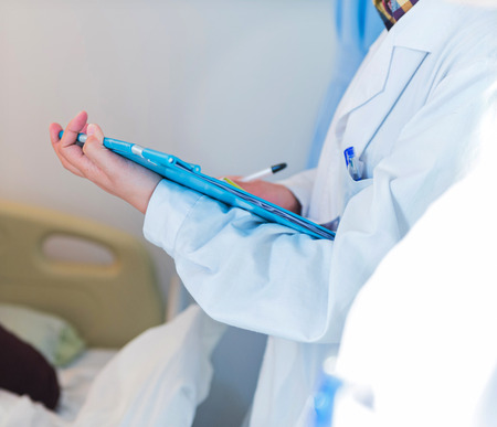 Medical team examining patient in hospital.の写真素材