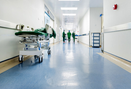 Doctors and nurses walking in hospital hallway, blurred motion.のeditorial素材