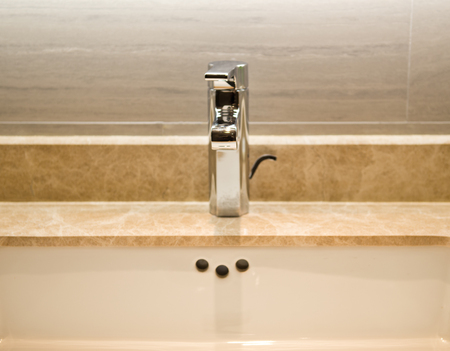 Closeup of sink and faucet in modern bathroom.の写真素材