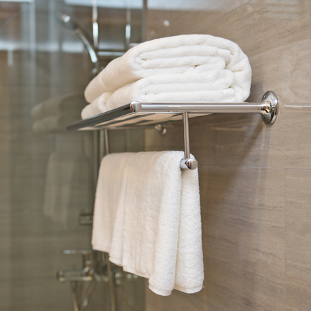 Clean white towel on a hanger prepared to use.の写真素材
