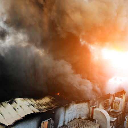 Fire burning and black smoke over the house.の写真素材