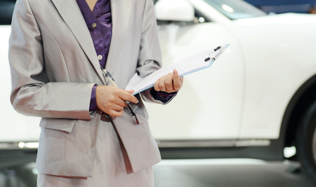 Car seller with car in a motor show.の写真素材