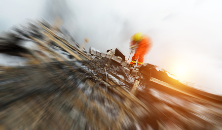Search and rescue forces search through a destroyed building with the help of rescue dogs.の写真素材