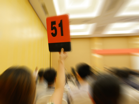 People holding auction paddle to buy from auction.の写真素材