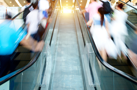 People rush on escalator motion blurred.の写真素材