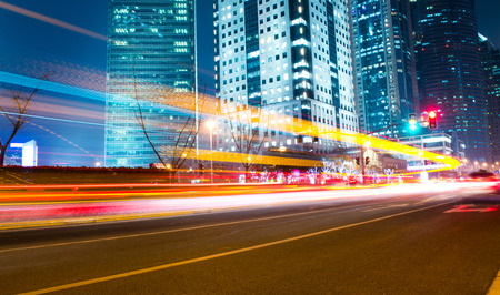 moving car with blur light through modern city at night.の写真素材