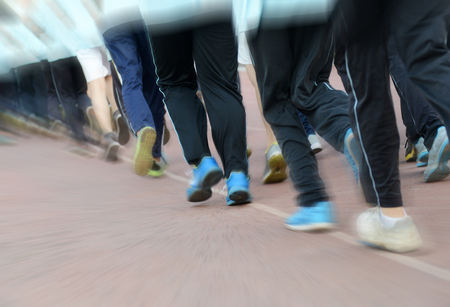 Group of students running on a racing track.の写真素材