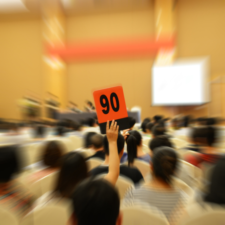 People holding auction paddle to buy from auction.の写真素材