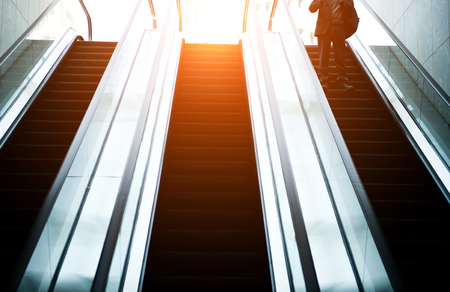 Low angle view looking to top of modern escalator with blue tone.のeditorial素材