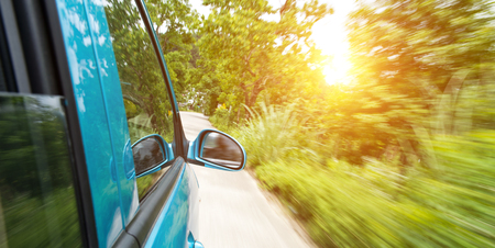 car driving fast into forestの写真素材