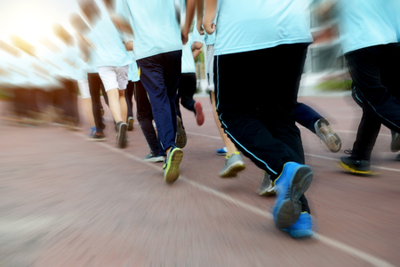 Group of students running on a racing track.の写真素材