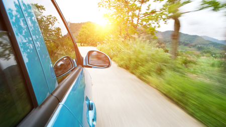 car driving fast into forestの写真素材