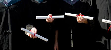 people in a gown holding a diploma.のeditorial素材
