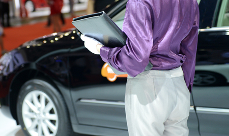 Car seller with car in a motor show.の写真素材