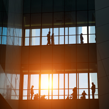 silhouettes of business people rushing at morden office building.のeditorial素材