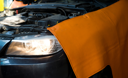Car in auto repair shop with open hood.のeditorial素材