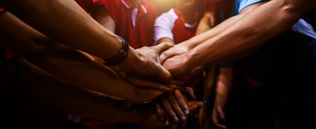 Sports team showing unity with their hands togetherの写真素材