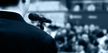 Businessman making a speech in front of crowdsの写真素材