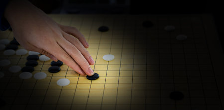 Detail of woman hand playing chinese boardgameの写真素材